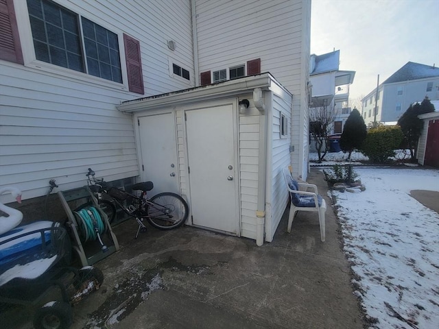 view of snow covered property entrance