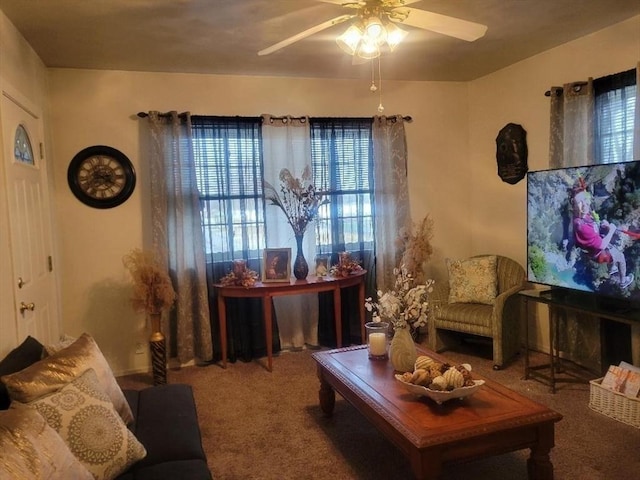 sitting room with ceiling fan and carpet flooring