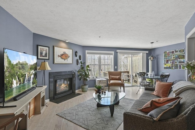 living room featuring light hardwood / wood-style floors and a textured ceiling