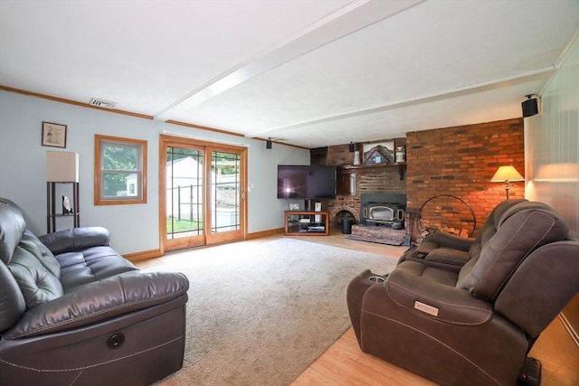 40 Old Stage Rd, Chelmsford, MA 01824 - living area with baseboards, ornamental molding, a wood stove, carpet, and beamed ceiling