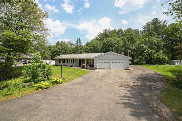40 Old Stage Rd, Chelmsford, MA 01824 - view of front of home with asphalt driveway, an attached garage, a front lawn, and a chimney