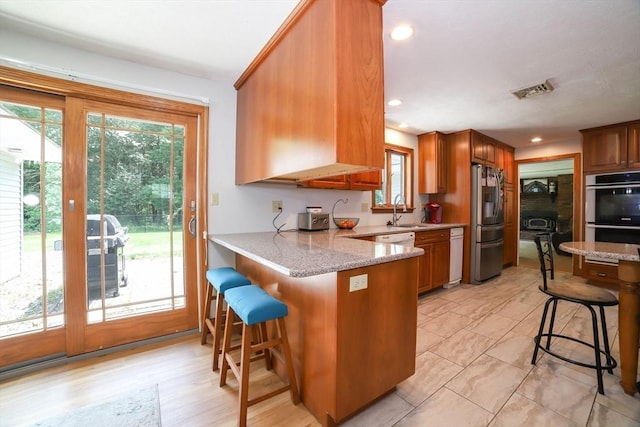 40 Old Stage Rd, Chelmsford, MA 01824 - kitchen with appliances with stainless steel finishes, a kitchen bar, a sink, healthy amount of natural light, and recessed lighting