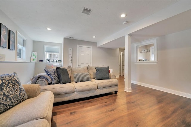 living room with decorative columns, recessed lighting, visible vents, wood finished floors, and baseboards