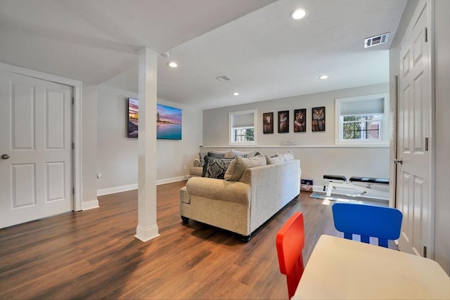 living room with recessed lighting, a healthy amount of sunlight, and dark wood finished floors