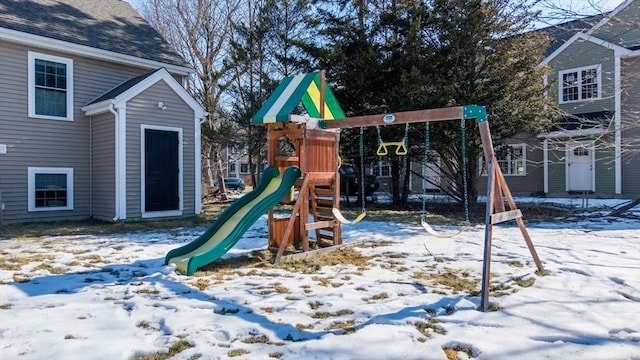 snow covered playground featuring a playground