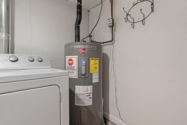 clothes washing area featuring washer / dryer, water heater, and laundry area