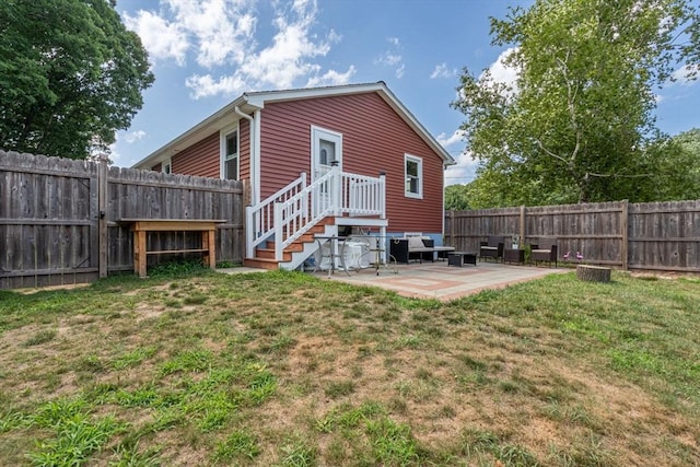 back of house with a yard, a fenced backyard, and a patio