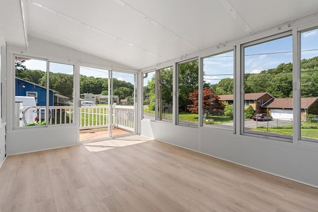 unfurnished sunroom featuring lofted ceiling