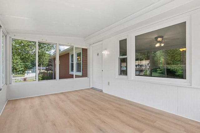 unfurnished sunroom featuring a ceiling fan