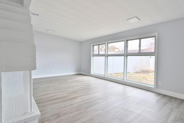 unfurnished living room with wood finished floors and baseboards