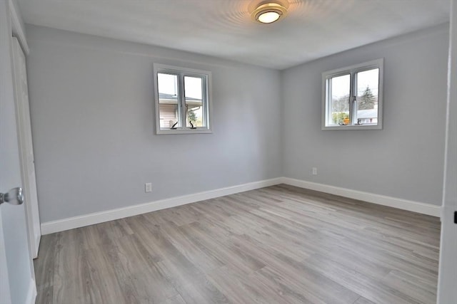 empty room with wood finished floors and baseboards