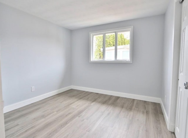 unfurnished room featuring light wood-style floors and baseboards