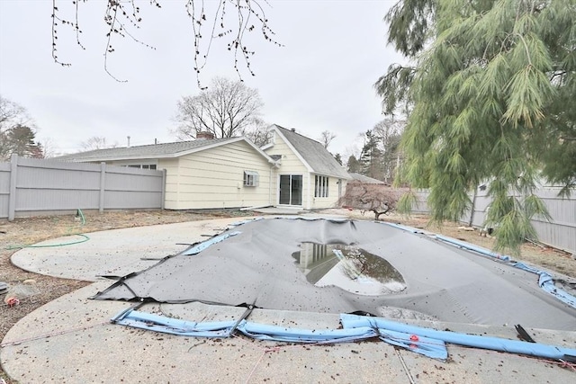 rear view of house featuring a fenced backyard