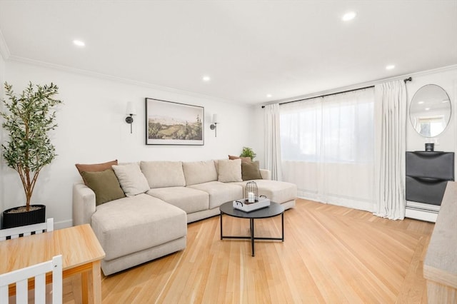 living room featuring crown molding, baseboard heating, and light hardwood / wood-style floors