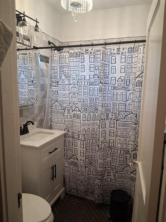 513 Washington Ave, Chelsea, MA 02150 - bathroom with toilet, vanity, and a shower with curtain