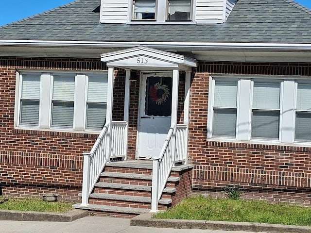 513 Washington Ave, Chelsea, MA 02150 - entrance to property featuring a shingled roof and brick siding