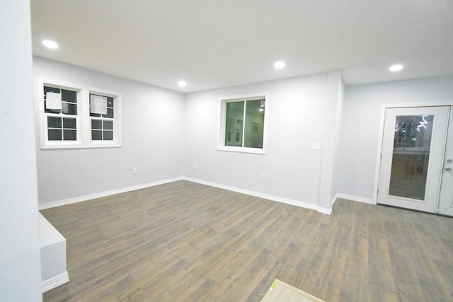 unfurnished room with dark wood-type flooring