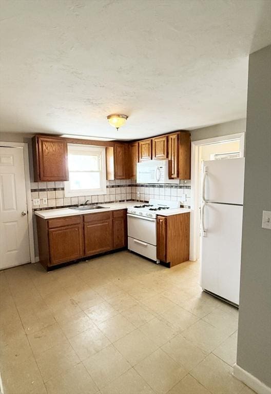 5-7 Monk St, Stoughton, MA 02072 - kitchen featuring white appliances, brown cabinets, light countertops, and backsplash
