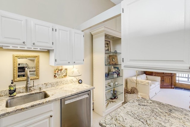 kitchen featuring dishwasher, light carpet, white cabinets, sink, and light stone counters