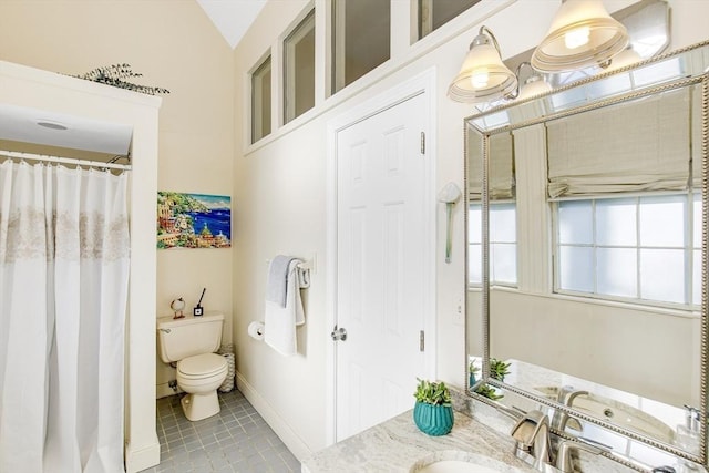 bathroom with tile patterned flooring, vanity, toilet, and lofted ceiling