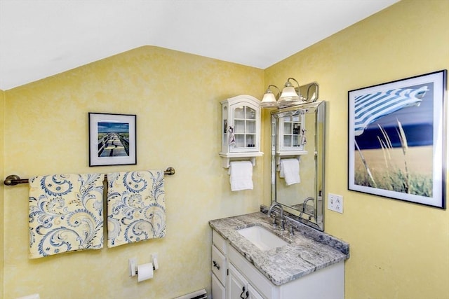 bathroom with vanity and lofted ceiling