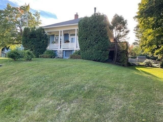 exterior space with a front yard and covered porch