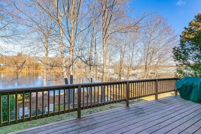 deck featuring area for grilling and a water view