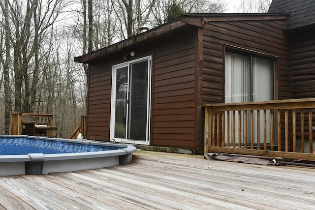 wooden deck featuring an outdoor pool