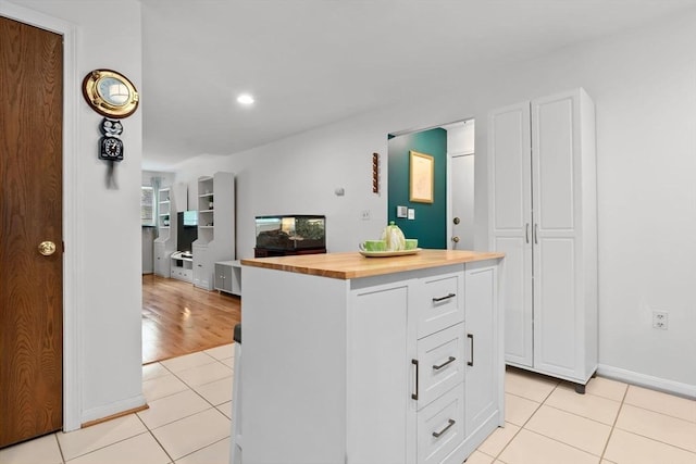 29 1st St Unit C, Salem, MA 01970 - kitchen featuring wood counters, light tile patterned floors, white cabinets, a center island, and recessed lighting