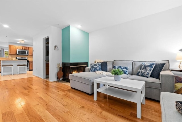 29 1st St Unit C, Salem, MA 01970 - living room with light wood-style flooring, recessed lighting, and a multi sided fireplace