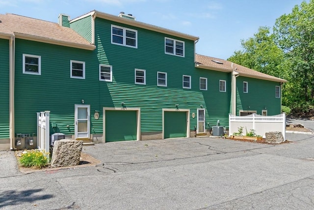 29 1st St Unit C, Salem, MA 01970 - view of front of home with driveway, a garage, and a chimney
