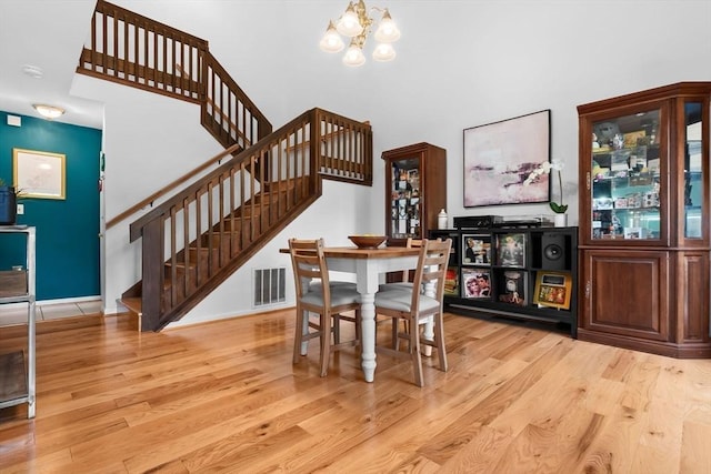 29 1st St Unit C, Salem, MA 01970 - dining area featuring stairs, wood finished floors, a chandelier, and a high ceiling