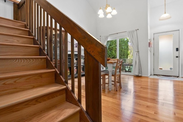 29 1st St Unit C, Salem, MA 01970 - stairs with a chandelier, wood finished floors, and a towering ceiling