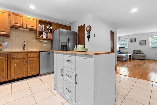 29 1st St Unit C, Salem, MA 01970 - kitchen with appliances with stainless steel finishes, light countertops, light tile patterned floors, recessed lighting, and a kitchen island