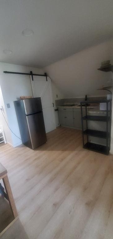 10 Monroe, Springfield, MA 01109 - interior space with a barn door, light wood-style flooring, and vaulted ceiling
