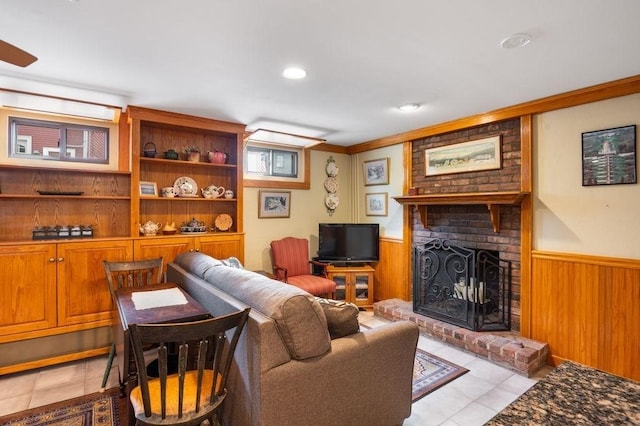 8 Franklin St Unit 18, Marblehead, MA 01945 - living area with light tile patterned floors, wainscoting, a brick fireplace, wood walls, and recessed lighting