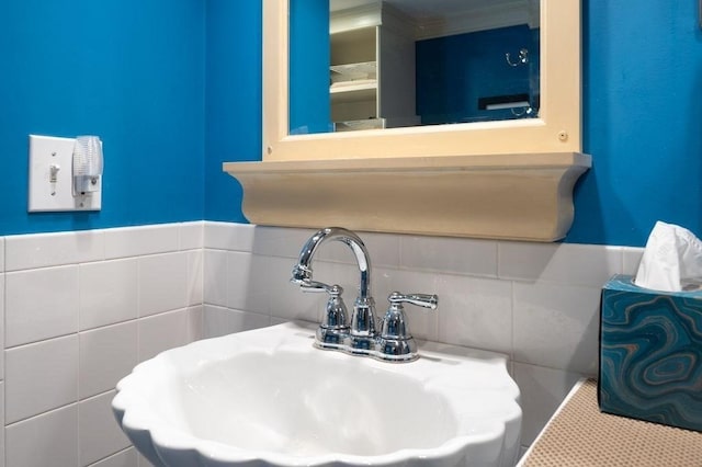 8 Franklin St Unit 18, Marblehead, MA 01945 - bathroom view of a sink, tile walls, and a wainscoted wall