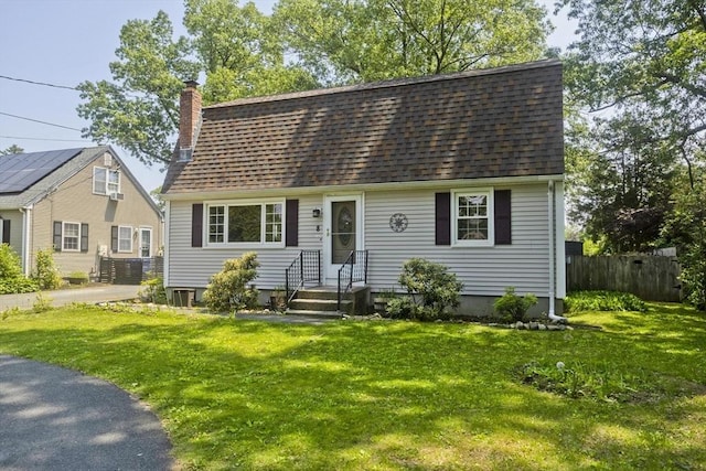 8 Field St, Southwick, MA 01077 - dutch colonial featuring a chimney, a shingled roof, and cooling unit