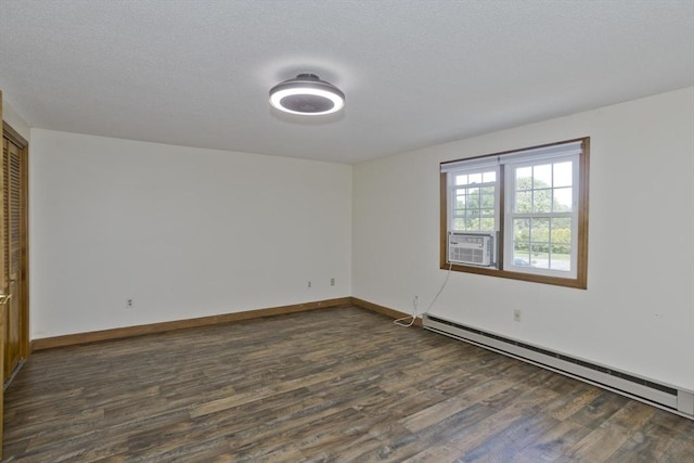 8 Field St, Southwick, MA 01077 - spare room with a baseboard heating unit, dark wood-style flooring, and baseboards