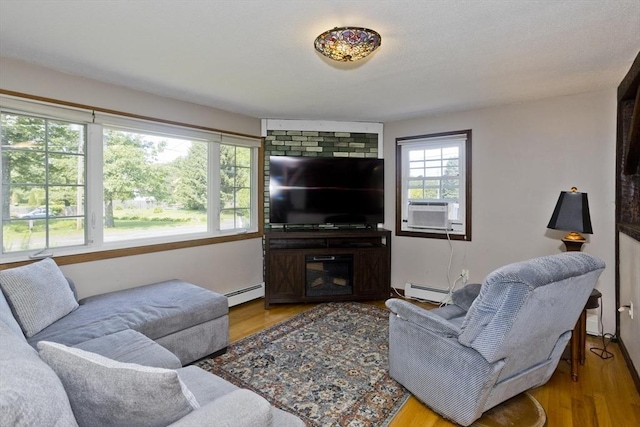 8 Field St, Southwick, MA 01077 - living area featuring a baseboard radiator, wood finished floors, and cooling unit
