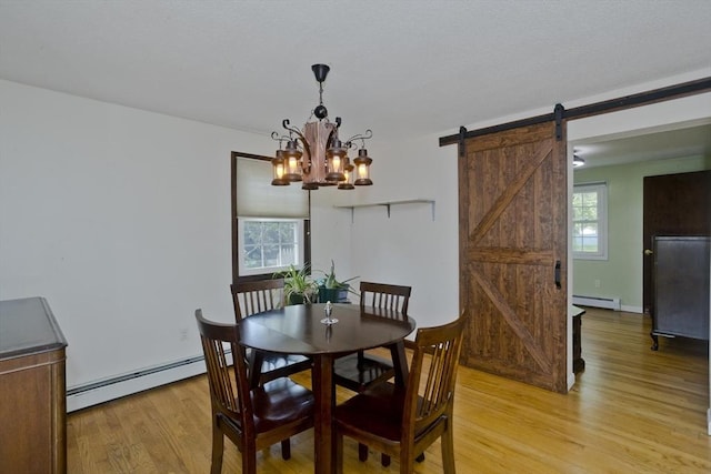 8 Field St, Southwick, MA 01077 - dining area with a baseboard heating unit, light wood finished floors, a baseboard radiator, a barn door, and a chandelier