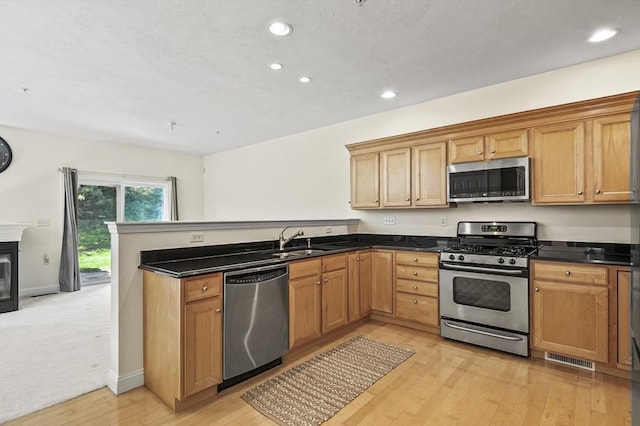 508 Linwood Ct Unit 508, Clinton, MA 01510 - kitchen featuring appliances with stainless steel finishes, a peninsula, recessed lighting, dark countertops, and light wood-style floors