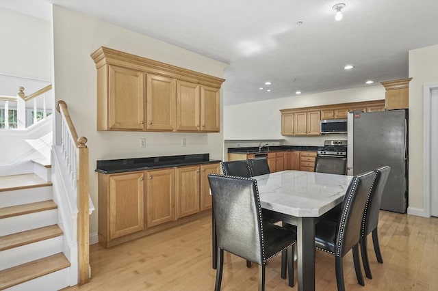 508 Linwood Ct Unit 508, Clinton, MA 01510 - kitchen with appliances with stainless steel finishes, light wood finished floors, recessed lighting, dark stone counters, and a breakfast bar area