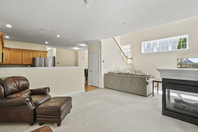 508 Linwood Ct Unit 508, Clinton, MA 01510 - living area with light colored carpet, recessed lighting, stairs, and a multi sided fireplace