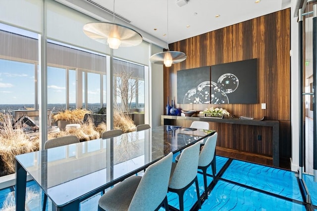 dining space featuring wood walls