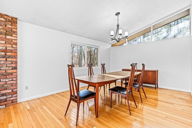 dining room featuring a notable chandelier and light wood-type flooring