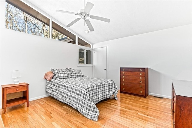 bedroom with lofted ceiling, ceiling fan, and light wood-type flooring