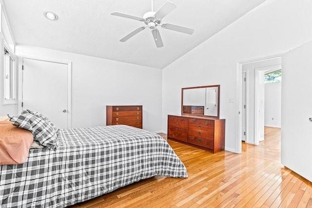 bedroom featuring ceiling fan, vaulted ceiling, and light wood-type flooring