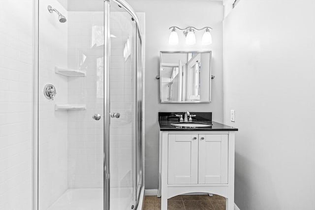 bathroom featuring vanity, tile patterned floors, and a shower with shower door