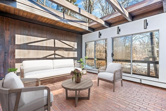 sunroom / solarium featuring a skylight, beamed ceiling, and a healthy amount of sunlight